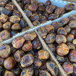 Surface-level view of a ripened brown Barhi date with caramel-like tones